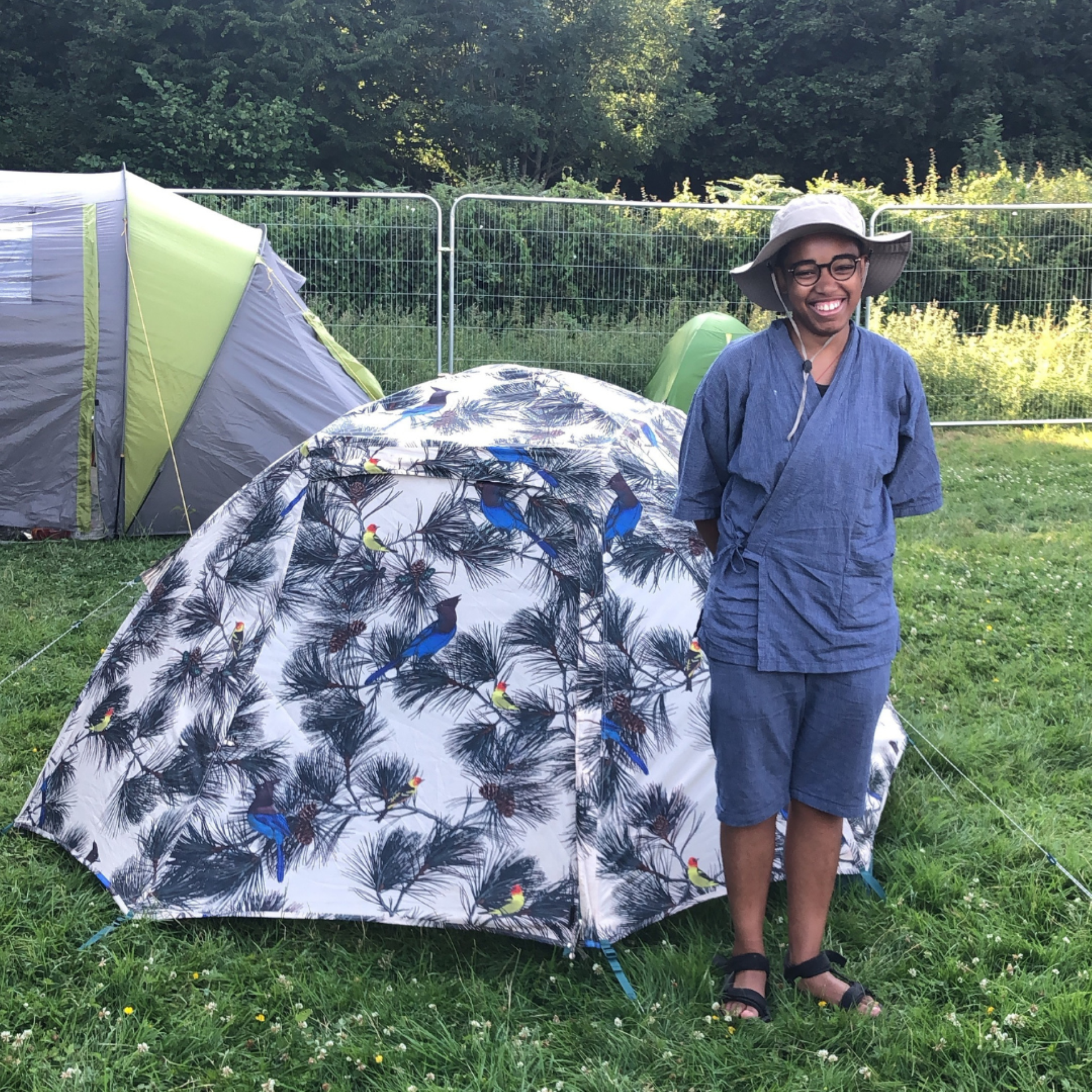 Child standing in front of tent