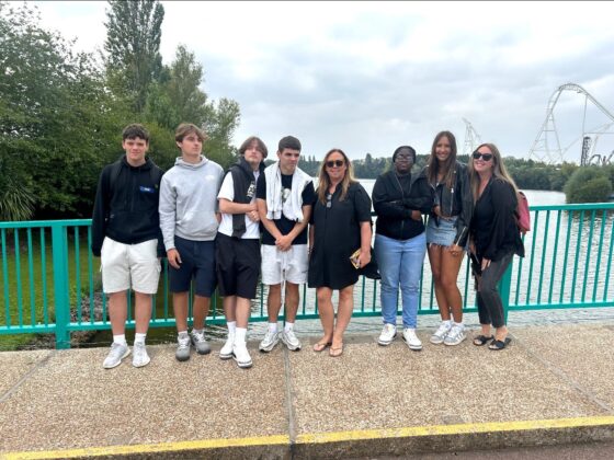 NW5 Director Sharley and her staff are pictured with young people on a scenic bridge over a waterway.